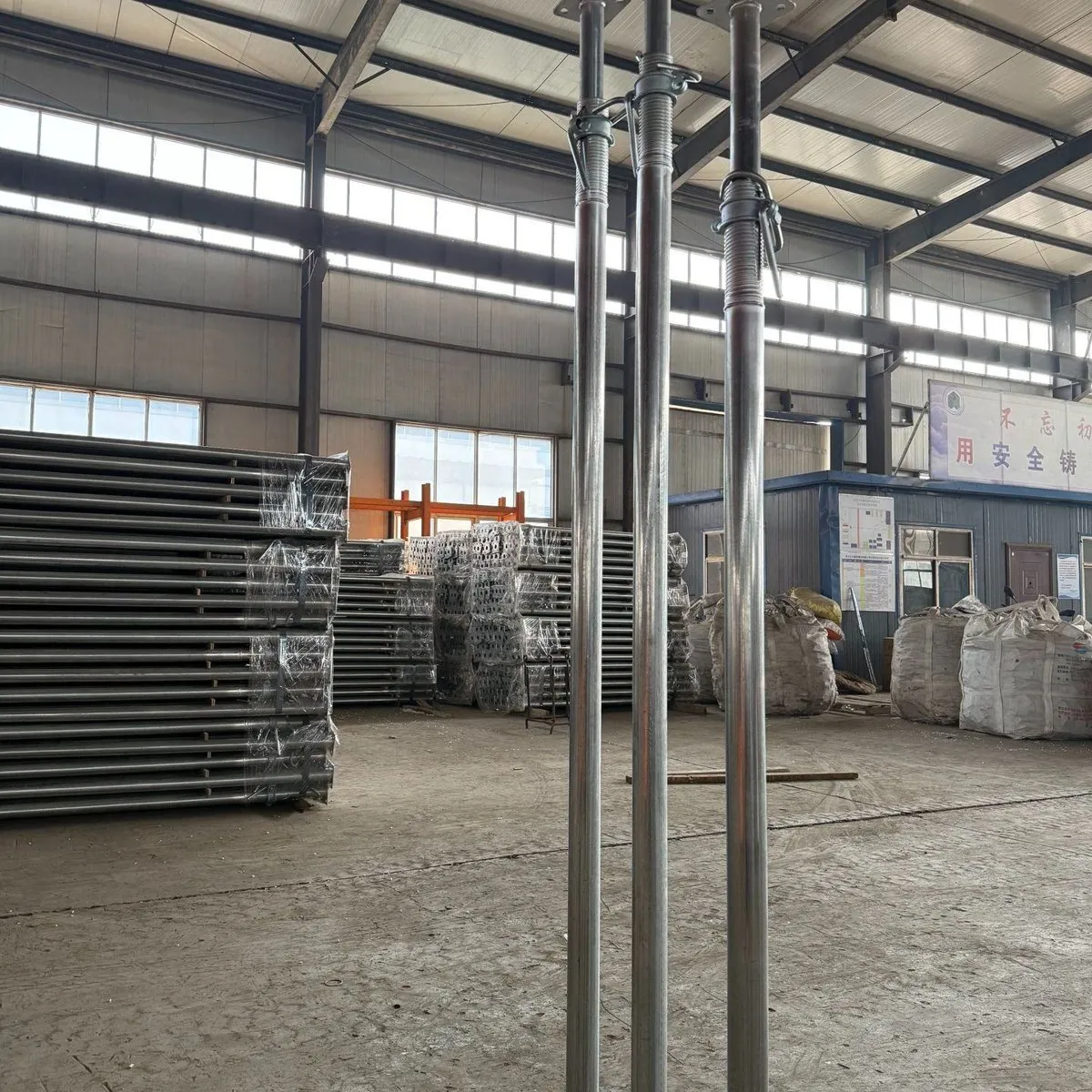 Adjustable steel props standing in the workshop